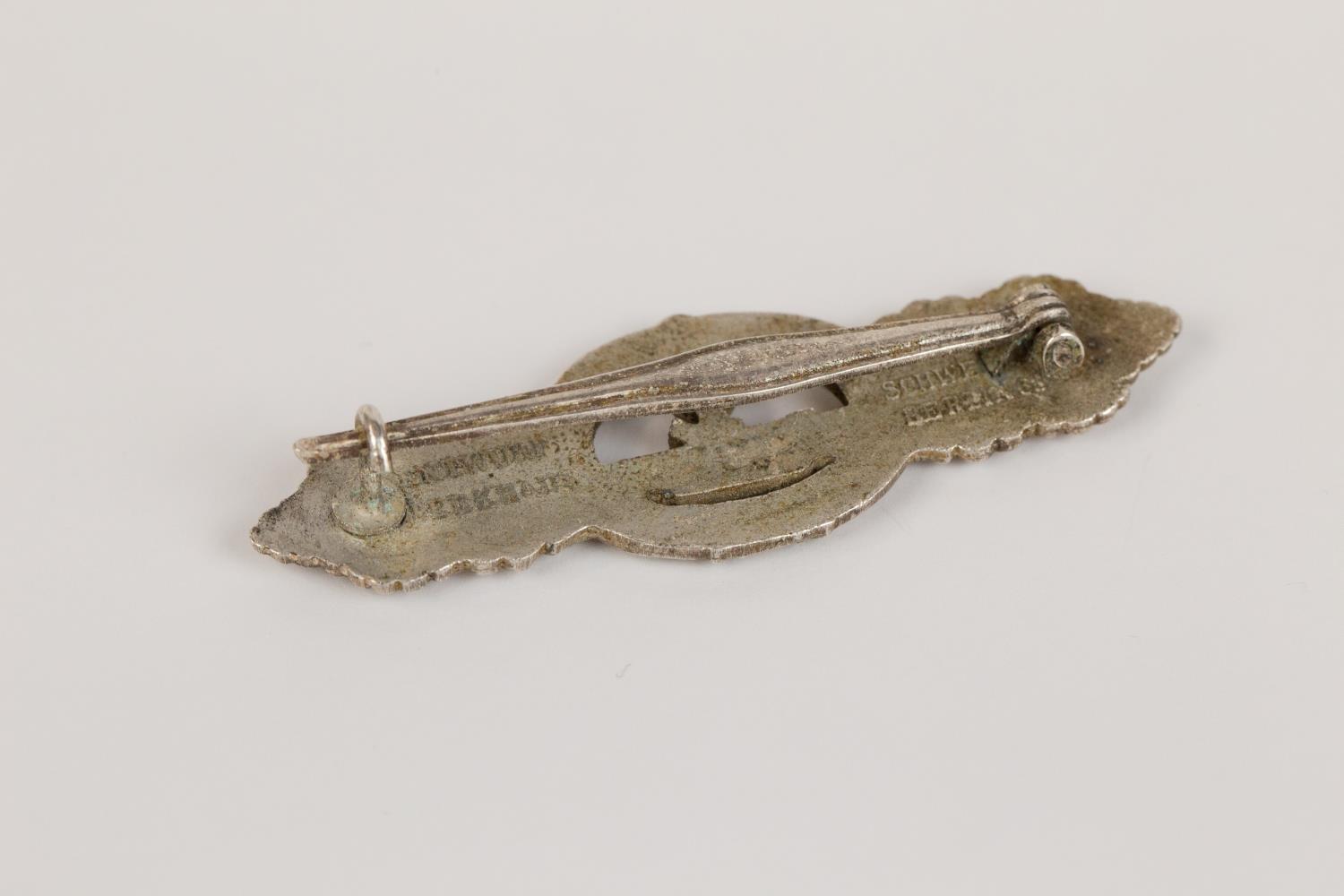 A Third Reich U boat clasp in silver, by Schwerin, Berlin, with ribbed pin and rough finish to the - Image 2 of 2