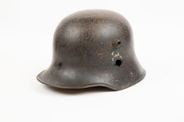 A German 1918 pattern steel helmet, with Third Reich Army decals (worn), and remains of the