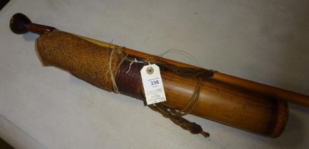 A Dyak blowpipe, together with an ornamental wooden dart quiver. GC £50-60