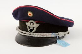 A Third Reich Fire Police officer's peaked cap, with police eagle badge, fibre peak, bullion
