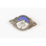 A silvered and enamel pin back badge for the IV Winter Olympics at Garmisch Partenkirchen, 1936,