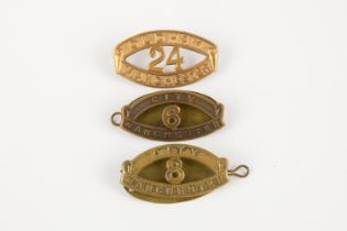 Three "Kitchener's Army" brass shoulder titles: 6th and 8th Manchester City Battalions, and 24th
