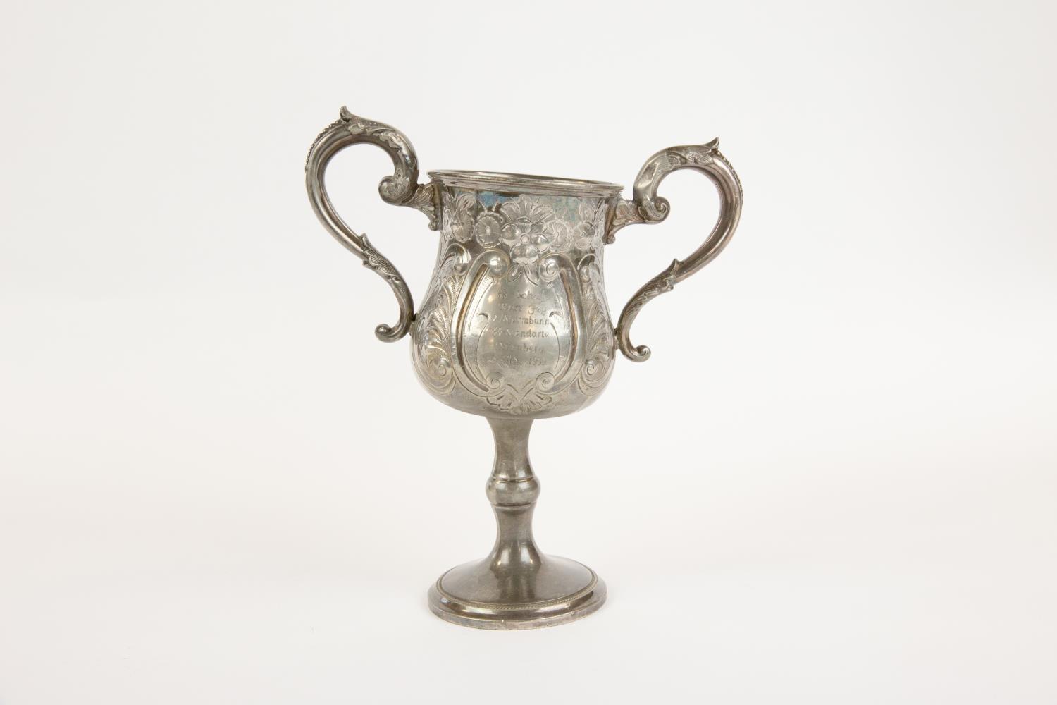 A pewter 2 handled prize footed cup, embossed with flowers and scrolls, a panel on one side engraved - Image 2 of 2