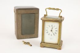 A brass cased carriage clock, by Arthur Baker, Carfax, Horsham, with carrying handle, GC and appears