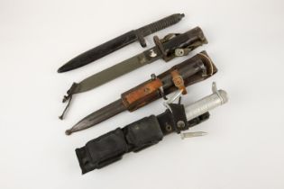 A Spanish M1969 Cetme bayonet, 2 other bayonets, and a German military knife, all with scabbards. GC