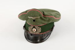 A Third Reich Panzer officer's peaked cap, with fibre peak, metal insignia, and pink piping. GC, the