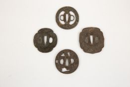 4 Japanese iron tsuba: pierced and embossed with a cow beneath flowering trees; another, lightly