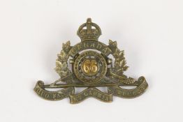WWI CEF cap badge of the 66th Overseas Field Battery Canadian Field Artillery, with two brass