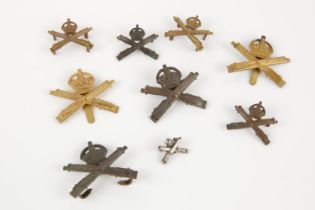 Machine Gun Corps badges: officer's bronze cap with blades (2); OR's brass with slider (2); pair