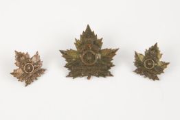 A WWI CEF cap badge of the 3rd Siege Battery Canadian Heavy Artillery, and a pair of matching collar