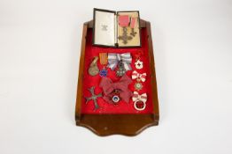 An interesting assemblage of awards etc, loosely tie mounted on display board, comprising: MBE,