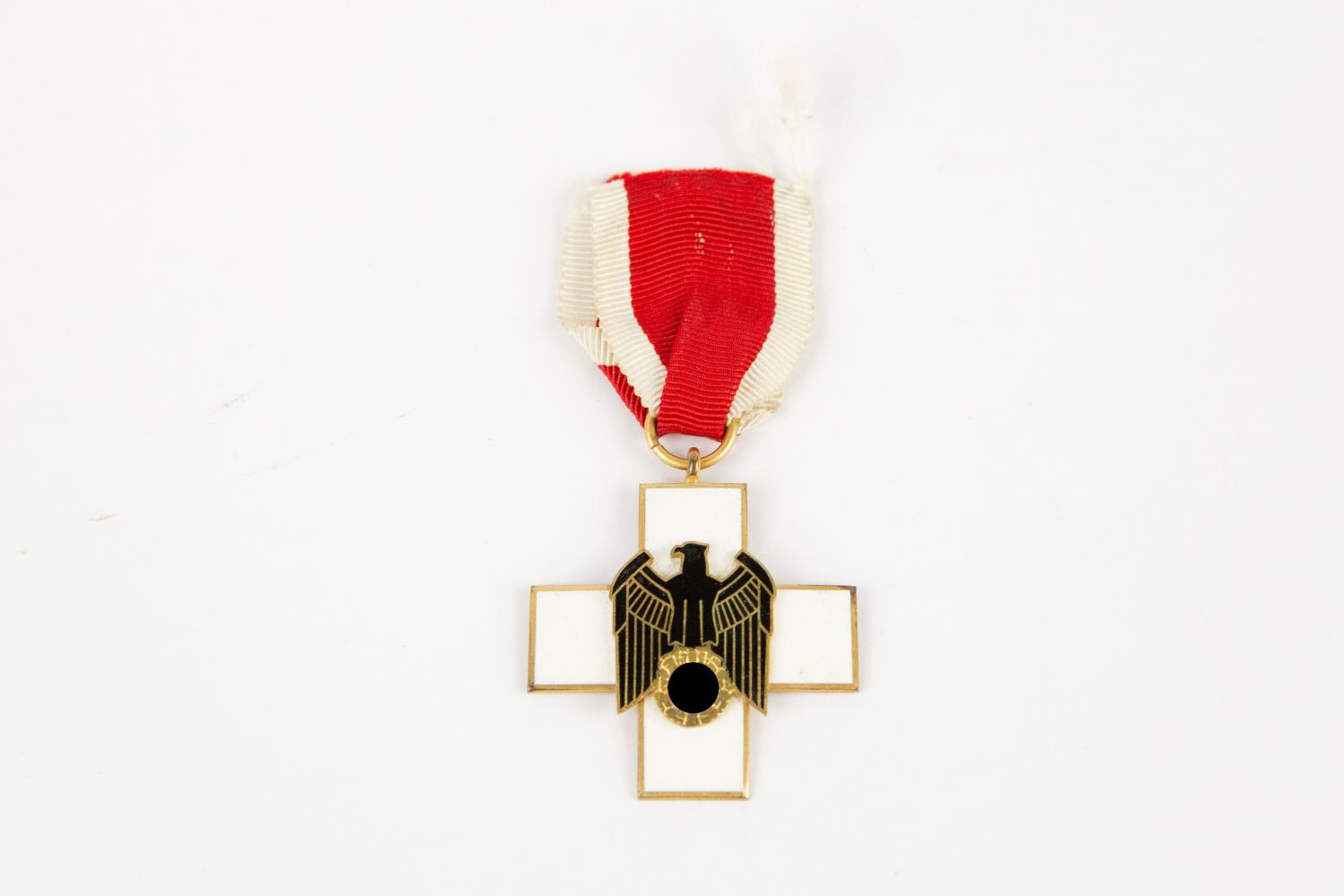 A Third Reich Social Welfare decoration 3rd Class, of gilt and enamel, with ribbon. GC £150-175