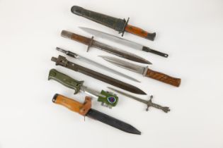 A Continental trench knife, blade 6½", wood grips, in its scabbard; another dated 1956; 2 more