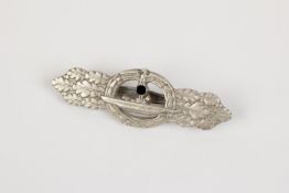 A Third Reich U boat clasp in silver, by Schwerin, Berlin, with ribbed pin and rough finish to the