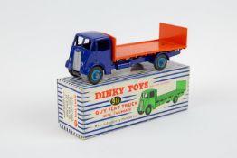 Dinky Toys Guy Flat Truck with tailboard (913). Cab and chassis in violet blue, with orange body and