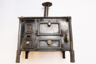 A scarce French late 19thc miniature cast iron cooking Range. With a makers mark 'ANGne Mon Godin