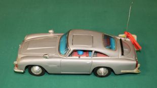 James Bond tinplate Aston Martin toy by Gilbert of America. Battery operated mechanism operates