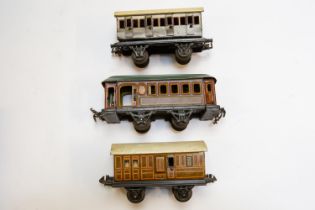 3 small German for the U.K. market tinplate 4 wheeled coaches. 2 by BING, a GWR 1st/3rd with opening