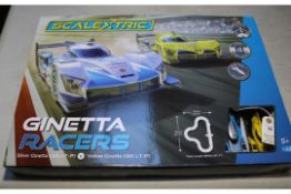 Scalextric Ginetta Racers 1:32 scale. Contains a silver Ginetta G60-LT-P1, and a yellow Ginetta