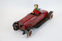 A very scarce 1920s Strutco toys Bearcat roadster wind up metal toy. Red body with black running