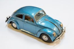A 1960's Japanese Bandai friction powered Volkswagen Beetle. Approximately 1:24 scale, finished in
