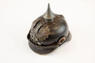 A WWI Prussian Pickelhaube, with iron badge, spike and mounts, and with chinstrap and rosettes,