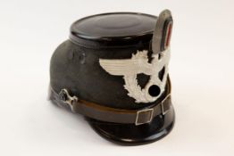 A Third Reich Police shako, with aluminium badge and cockade, leather chinstrap and lining, maker'