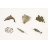 6 WWII German U boat metal badges: a smiling pig (U672), leaping dolphin (U308), oak leaves (