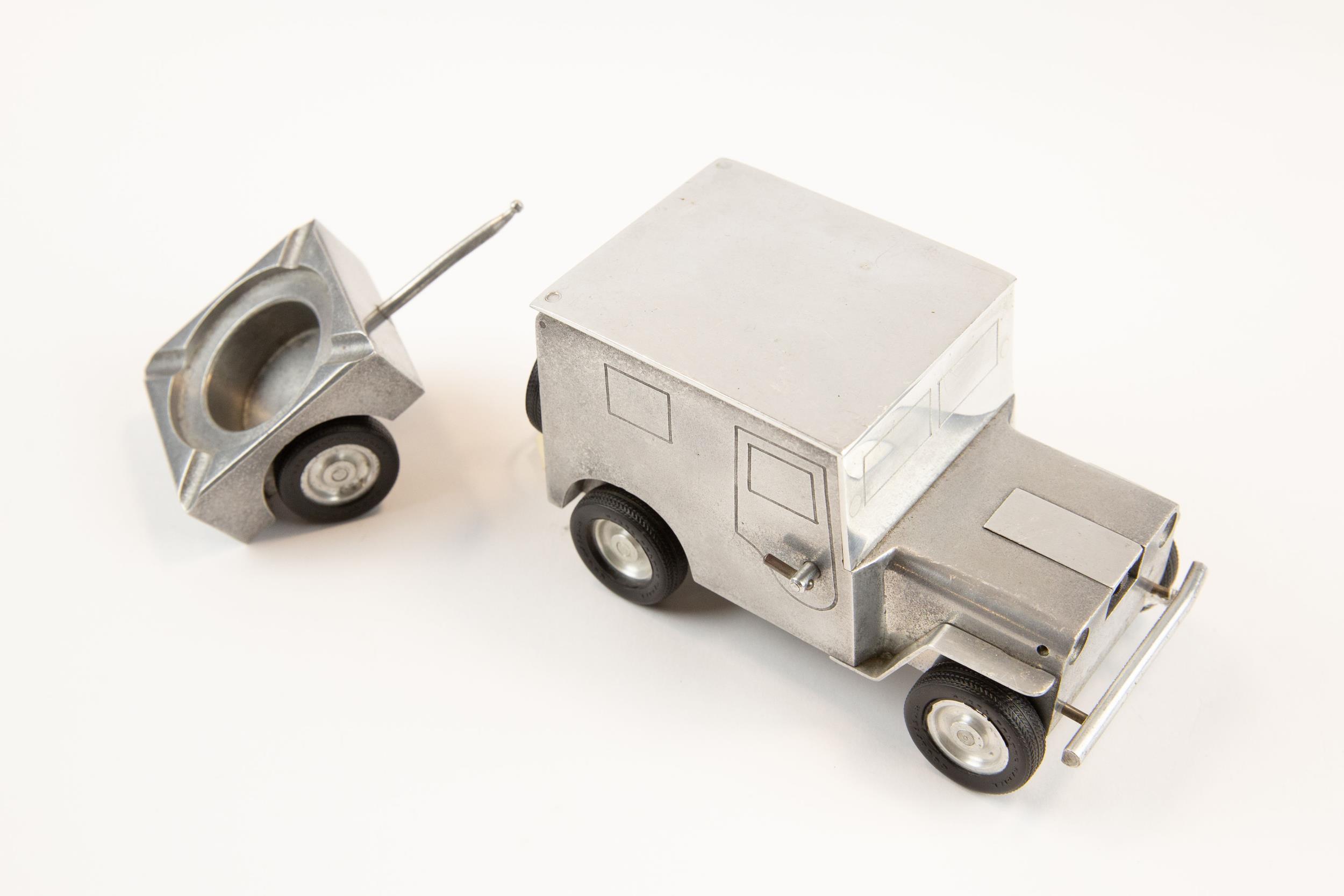 A post WWII German made souvenir "jeep" cigarette lighter; operating the door handles causes the