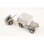 A post WWII German made souvenir "jeep" cigarette lighter; operating the door handles causes the