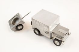 A post WWII German made souvenir "jeep" cigarette lighter; operating the door handles causes the