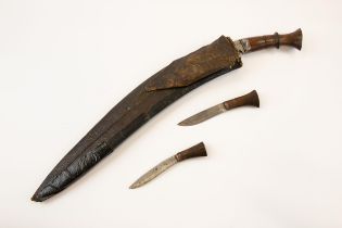 A good old large Kukri, blade 17½", in its leather scabbard complete with skinning knives. GC £60-70