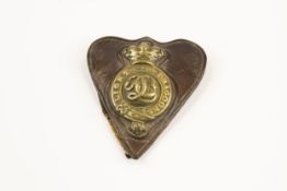 A Victorian Light Dragoons brass martingale badge, on its heart shaped leather backing containing