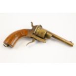 A late 19th century brass cigar cutter, in the form of a pin-fire revolver, 6½" overall, with