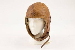 A scarce WWII Japanese fleece lined brown leather flying helmet, with integral 5 pointed star badge,