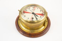 A ship's brass "Radio Silence" bulkhead clock, by Smiths, the face divided by coloured segments