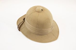 A khaki tropical helmet, probably 1940s, with leather lining and chinstrap. GC £60-80