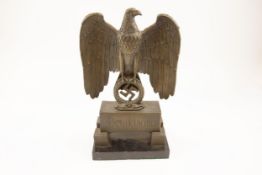 A large Third Reich bronzed brass standing eagle, on a rectangular base inscribed "Deutschland"