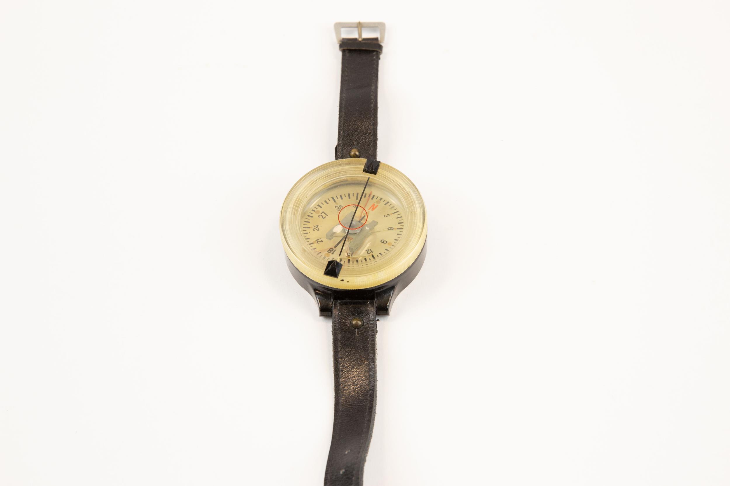 A scarce WWII German Luftwaffe pilot's wrist compass, of black bakelite and clear perspex, the