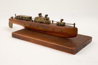 A "trench art" model motor launch, 15" overall, with wooden hull, and brass superstructure, rails