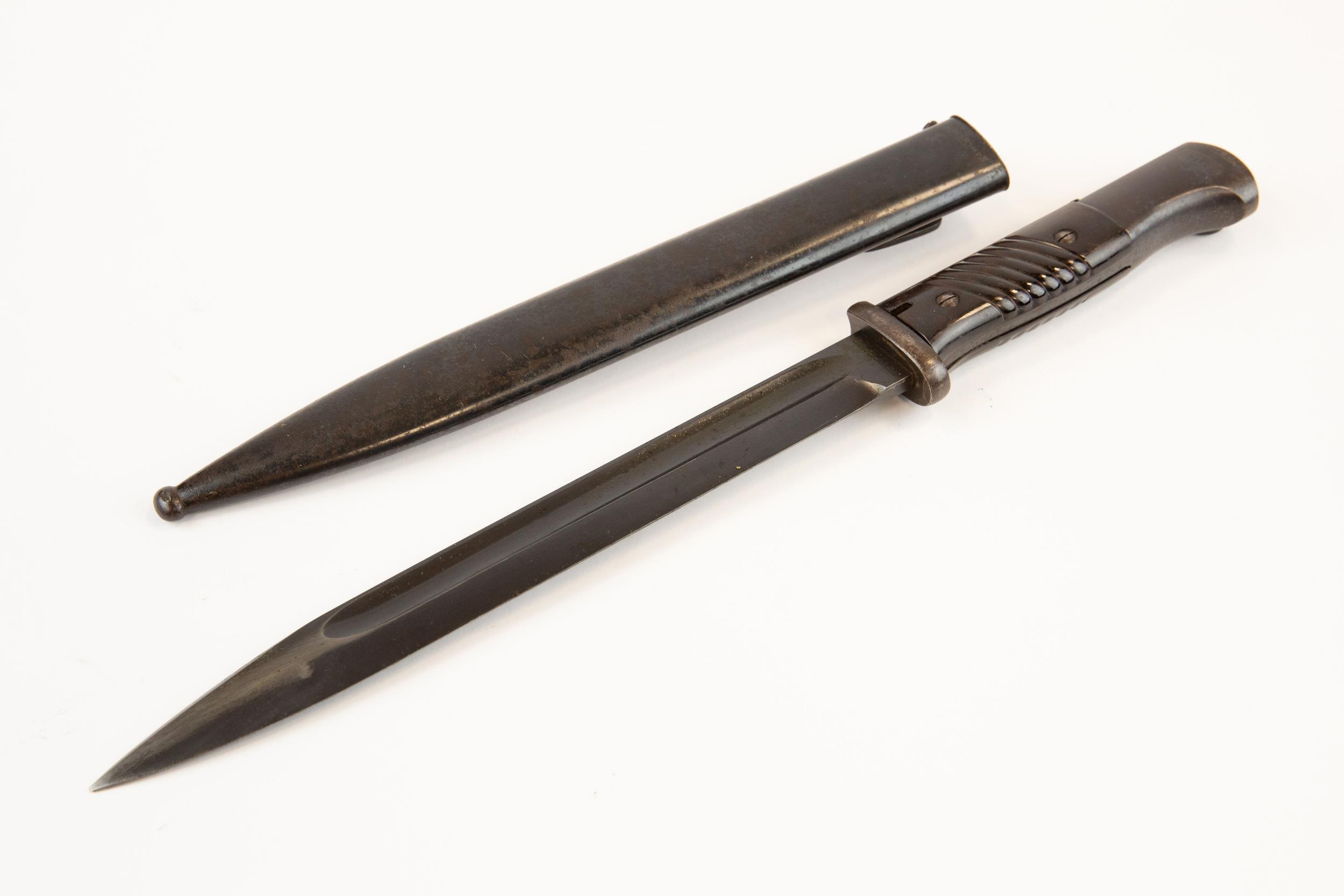 A Third Reich K98 bayonet, by Carl Eickhorn, with bakelite grip, in its scabbard dated 1939, the - Image 2 of 2