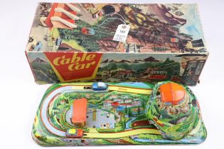 A Technofix cable car tinplate toy with 2 cable cars that move on a cable up and down, also 2 ti