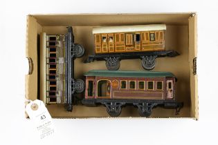 3 small German for the U.K. market tinplate 4 wheeled coaches. 2 by BING, a GWR 1st/3rd with opening