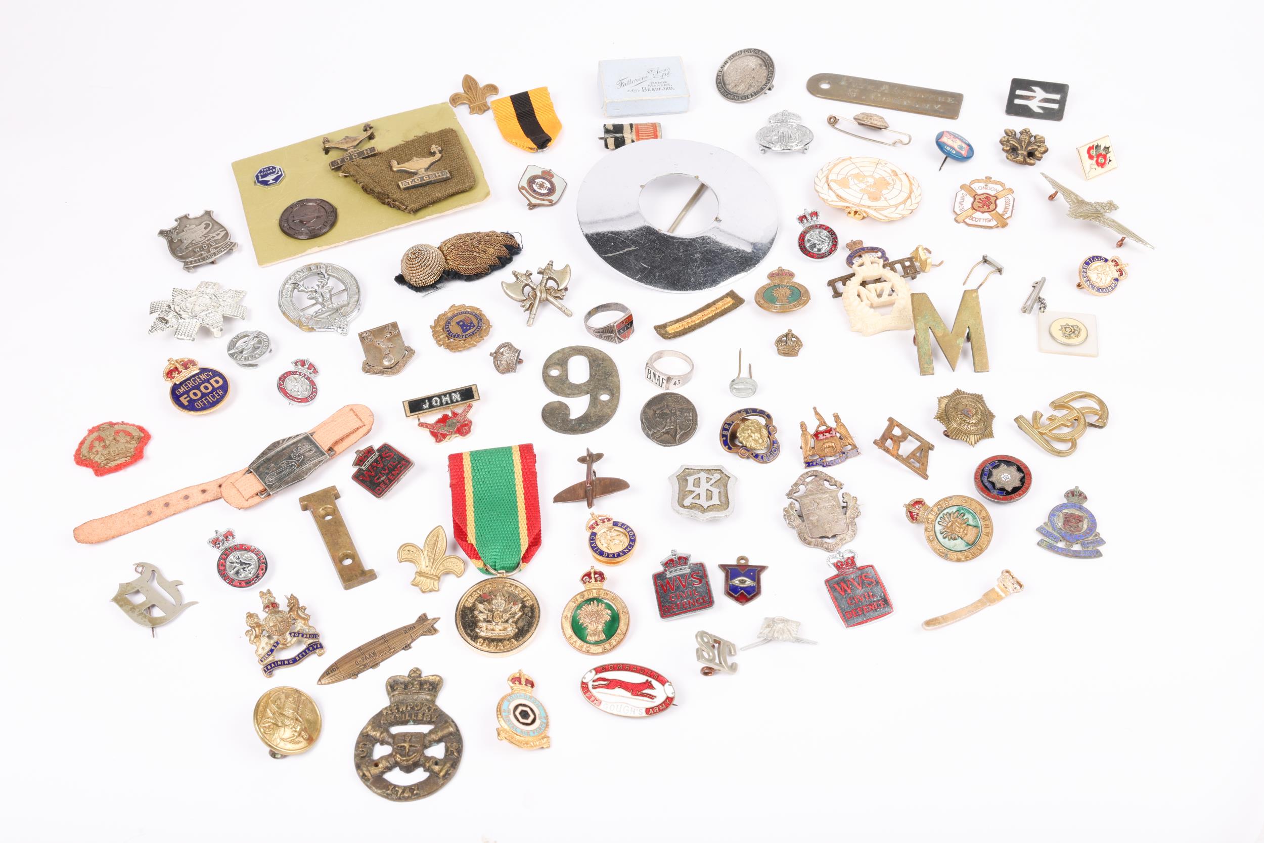 A "Toc H" brass badge on a piece of khaki uniform, another similar badge, a bronze "Toc H War