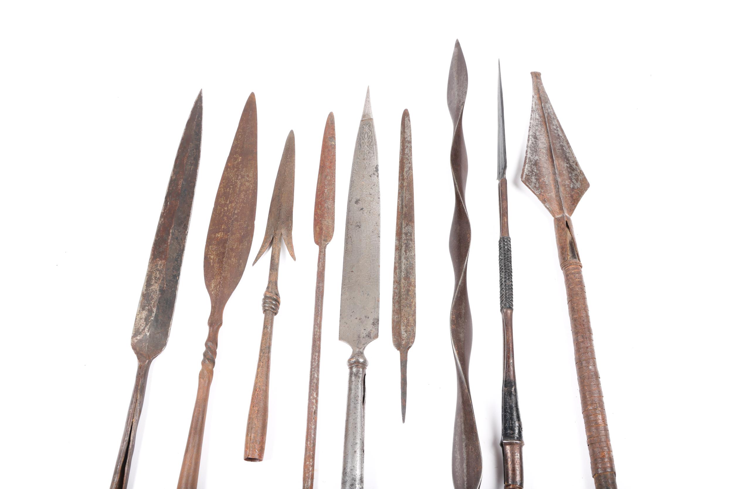 An African spear, with spatulate head, partly brass bound haft and long ...