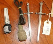 Two German paper knives, one in the form of a naval dagger, with plated blades and grey metal hilts,