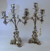 A impressive pair of very good quality silver plated candelabra depicting 3 sea serpents to each