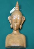 A finely carved Keradjinan Bali figure of a woman, with long face and floral design carved above the