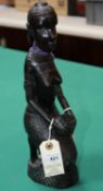 Hand carved figure of a tribal lady with baby on her back, Kneeling down holding a container, Damage