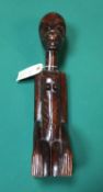 Hand carved wooden African tribal figure in kneeling position signed to the bottom of the left